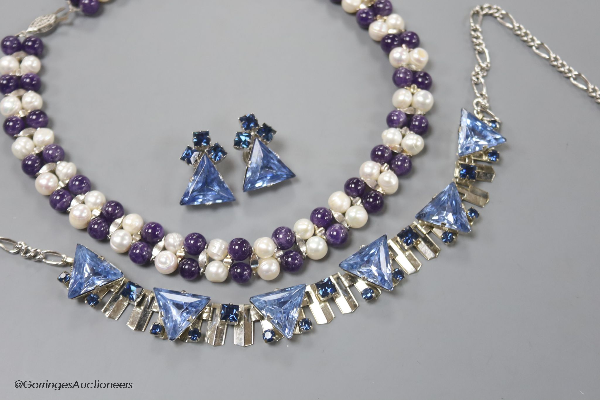 A modern amethyst bead and freshwater cultured pearls necklace and one other paste necklace and pair of earrings.